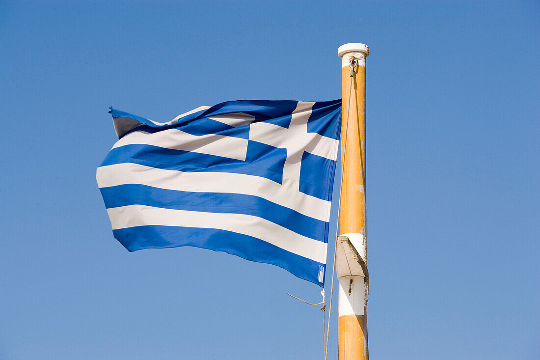 Greek flag fluttering in the wind, Mykonos, Greece