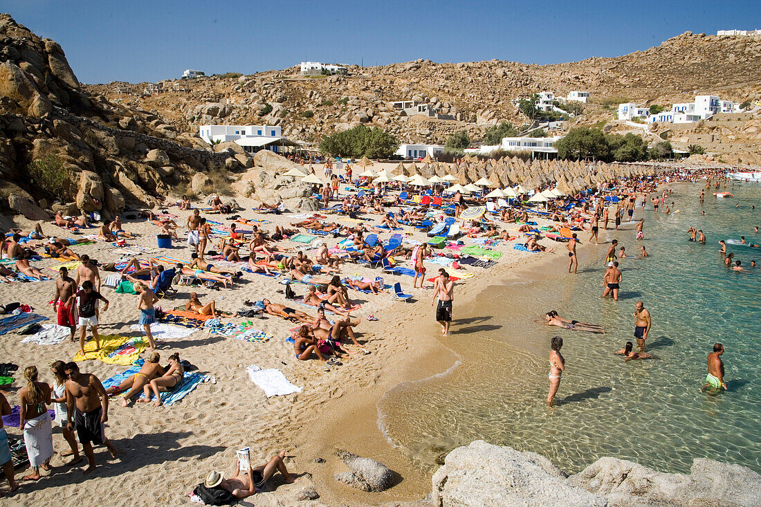People bathing at Super Paradise Beach, knowing as a centrum of gays and nudism, Psarou, Mykonos, Greece