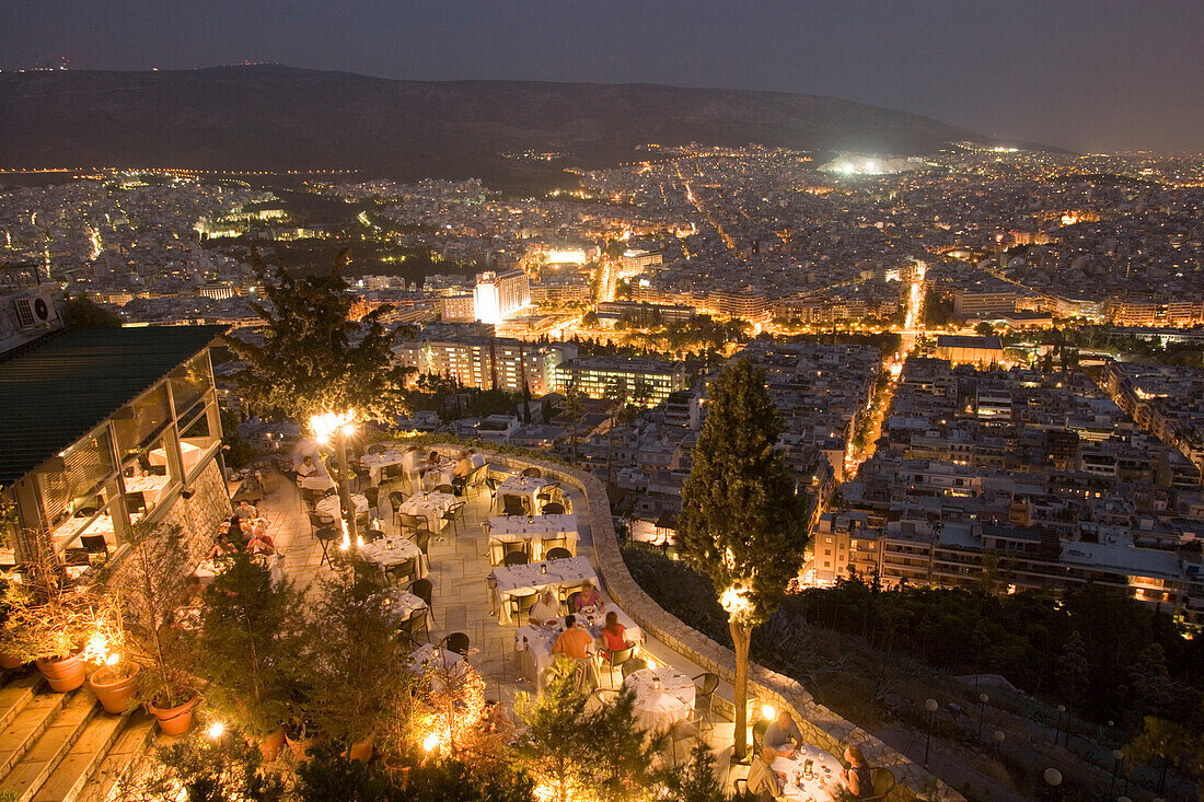 View from the Lykavittos Hill over the restaurant Orizontes to the ocean of houses of the town at night, Athens, Athens-Piraeus, Greece