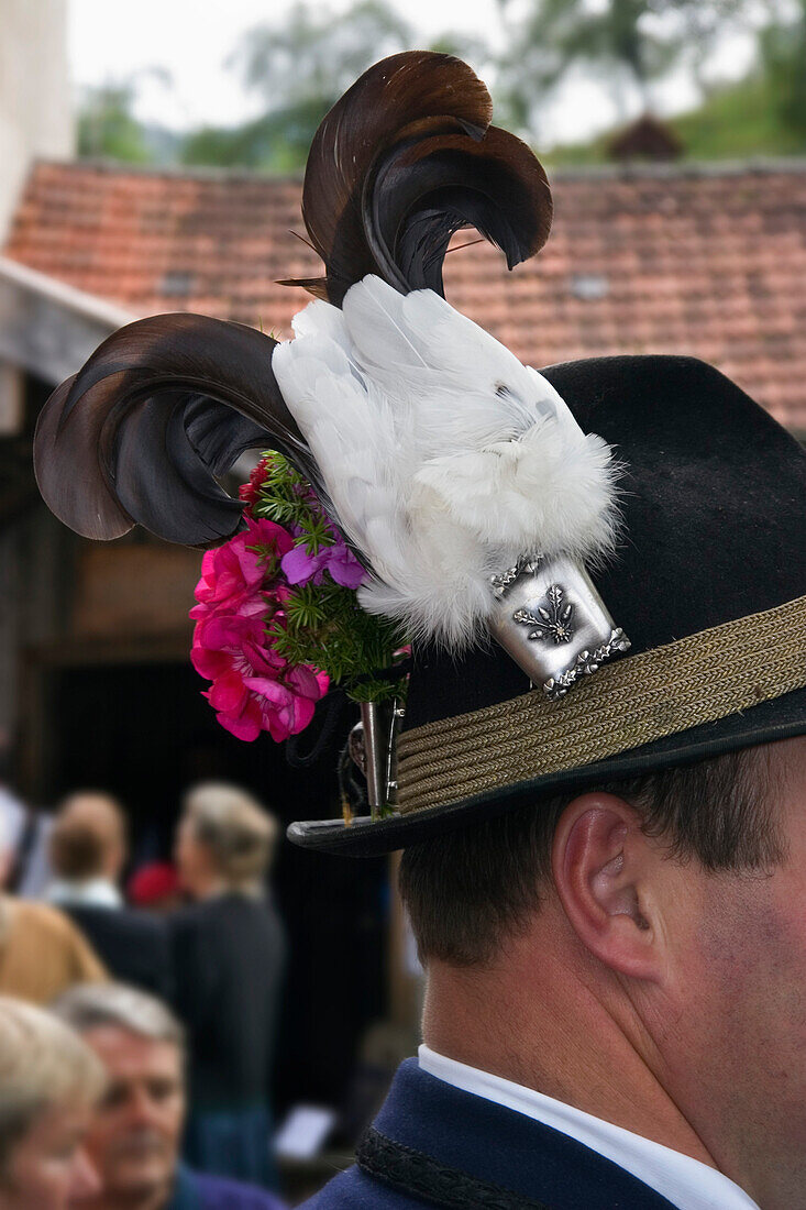 Man wearing traditional hat, decorated with Black Grouse feathers, Kochel, Upper Bavaria, Germany