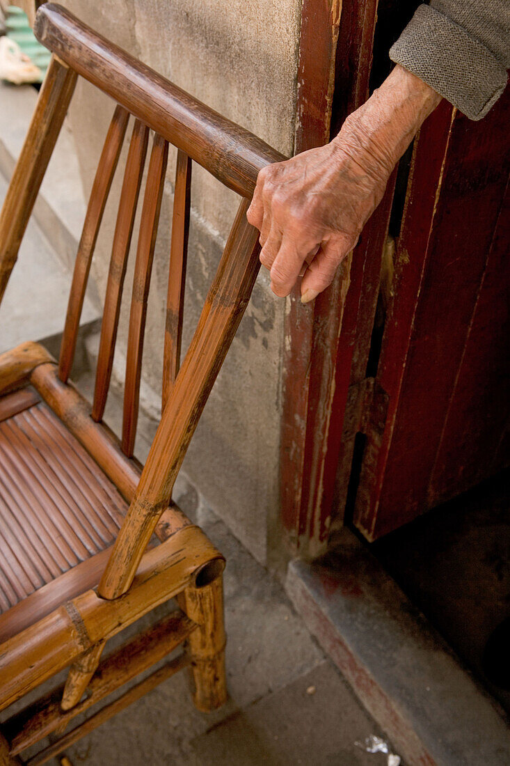 old bamboo chair, hand of an old lady, Design
