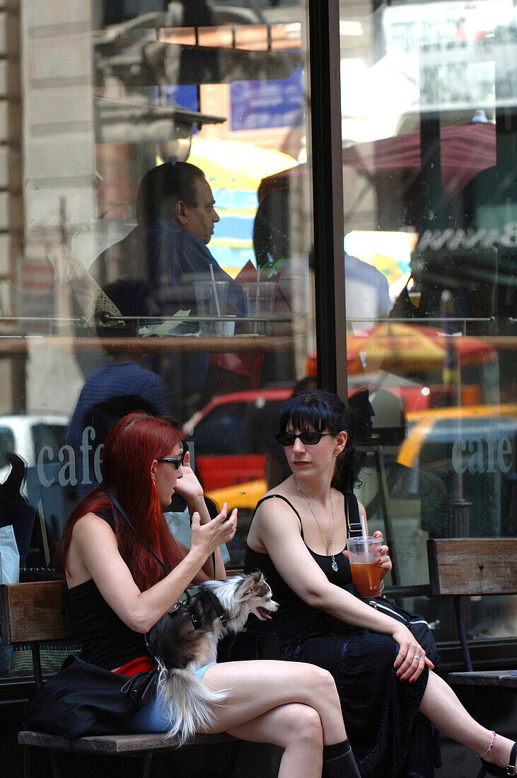 Two Women sitting infront of a Cafe in SoHo, Manhatten, New York, USA