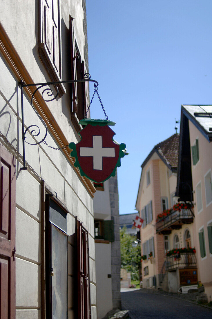House with swiss flag emblem, Guarda, Grisons, Switzerland