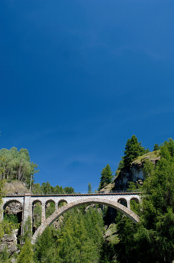 Viaduct under bright blue sky, Grisons, Switzerland