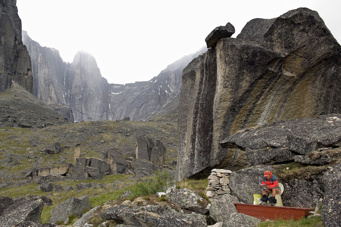 Man sitting on toilet, Cirque of the Unclimbables, Northwest-Territories, Canada