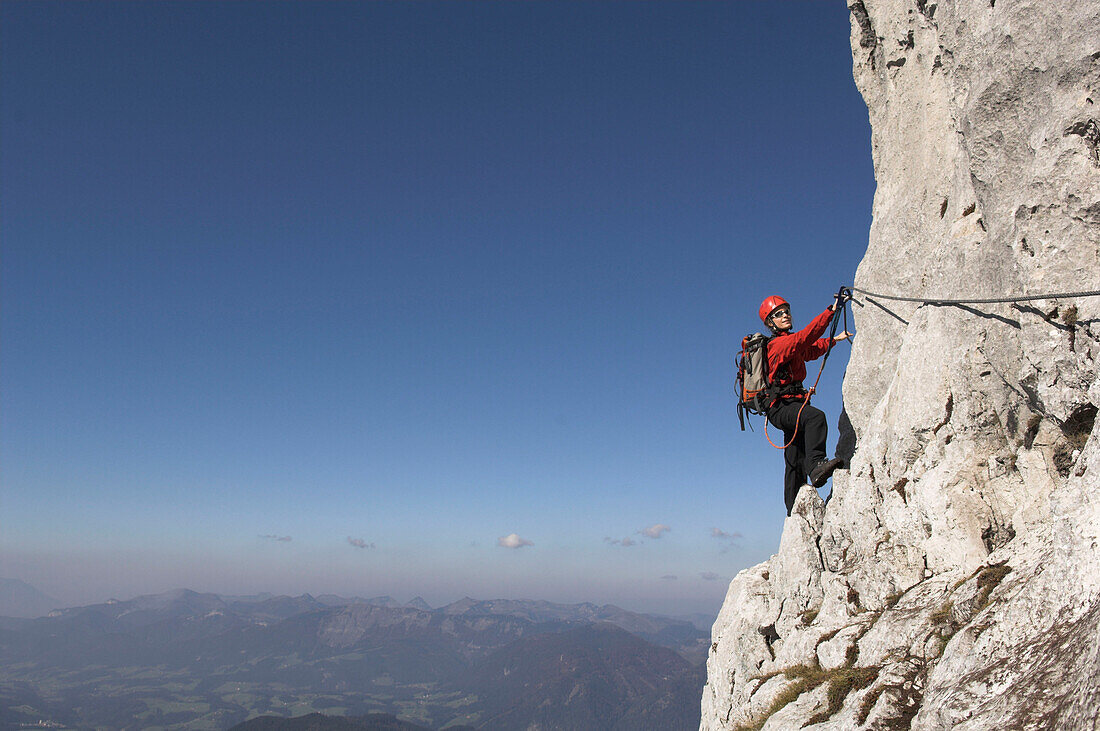 Young female climber at Donnerkogel fixed rope route, Gosaukamm, Dachstein Mountain, Austria