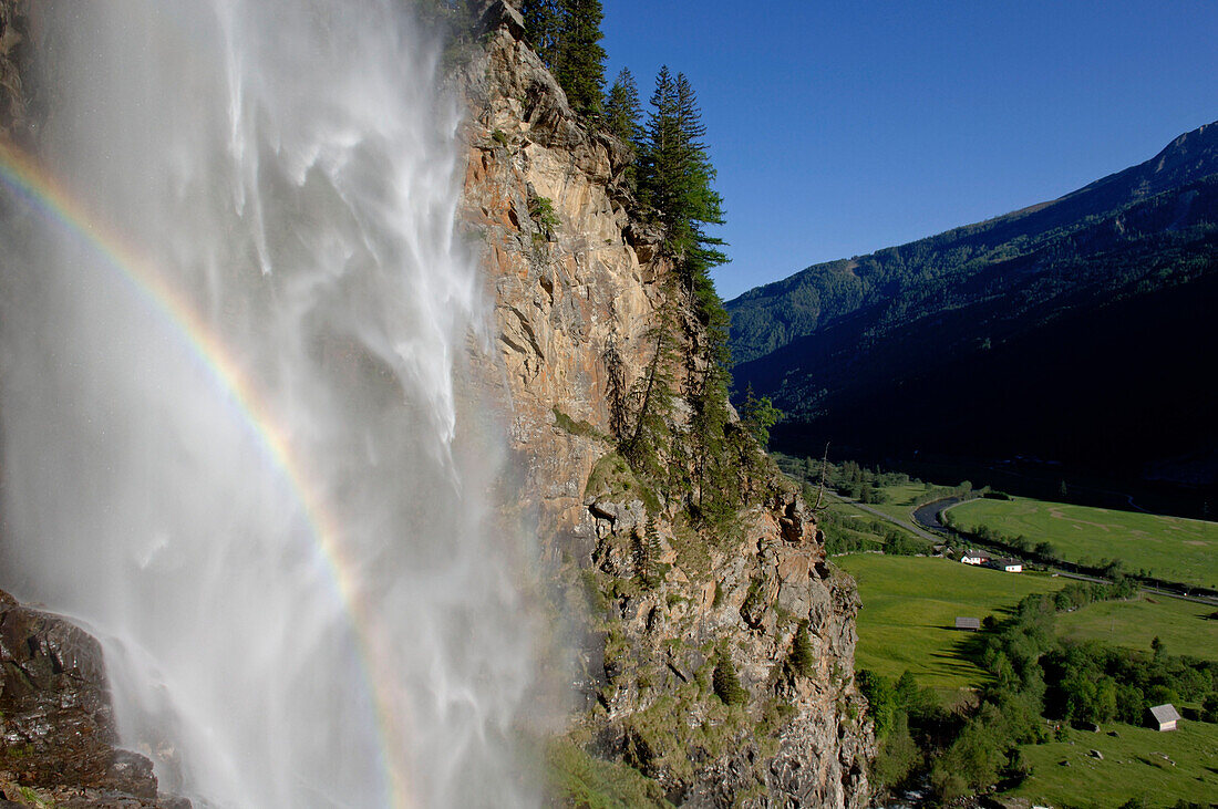 Rainbow in Waterfall, view over landscape, Carinthia, Austria