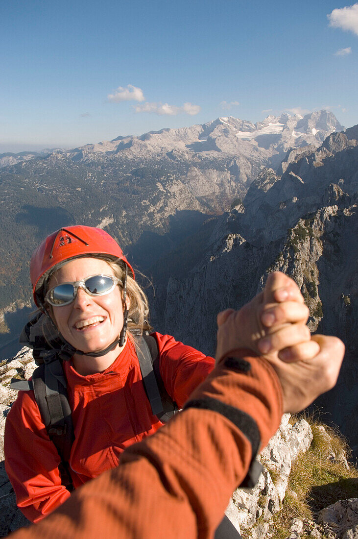 Shaking hands on summit of Donnerkogel, Gosaukamm, Salzkammergut, Austria