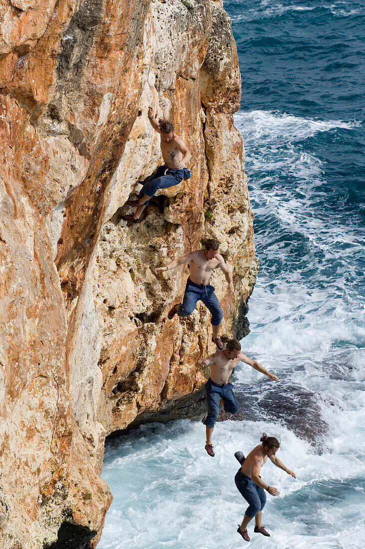 Man jumping into water from rock face, Coast of Majorca, Spain