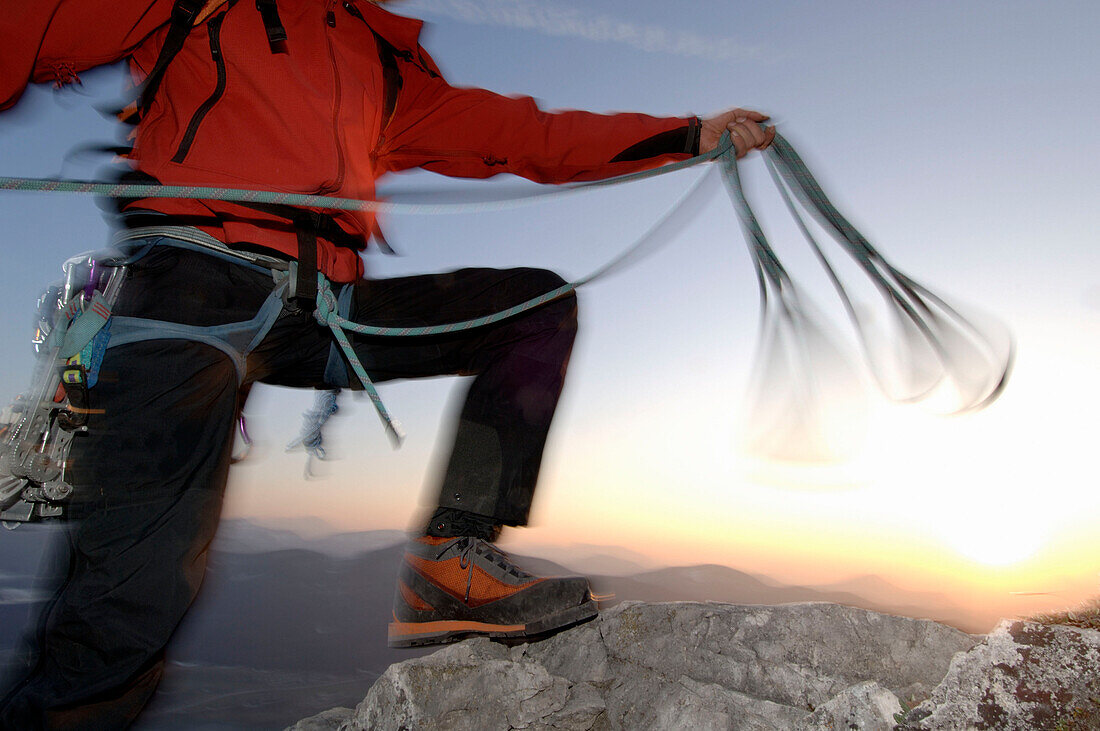 Climber handling rope on Schober Mountain, Salzburger Land, Österreich