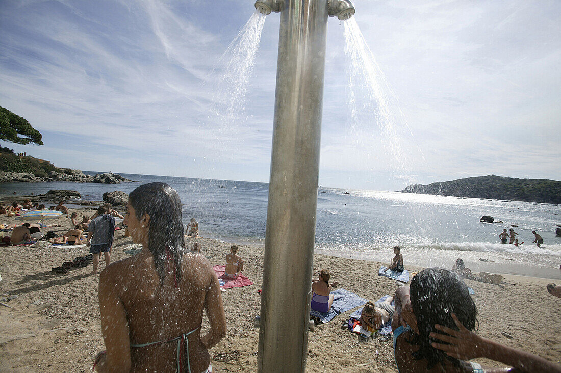 Costa Brava,Bathers, Shower on the beach at Calella, Costa Brava, Catalonia Spain