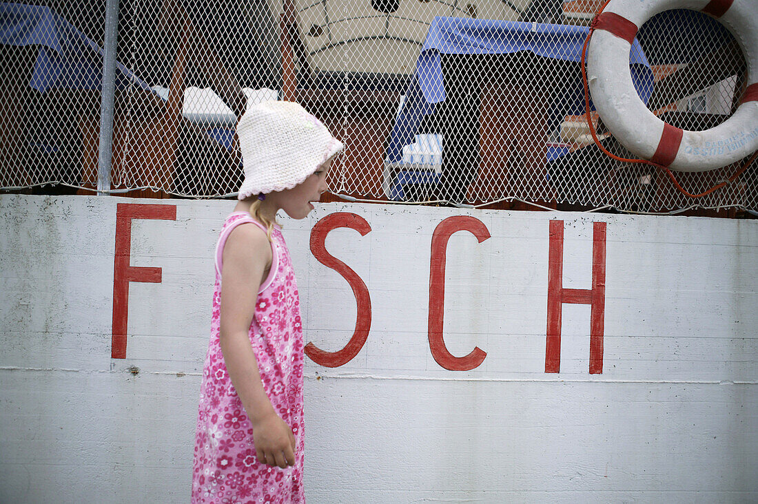 Little girl walking to fish restaurant, Valun, Cres Island, Croatia