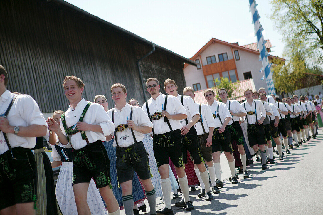 Young men in traditional bavarian clothes at the celebration of 1st May, Muensing, Bavaria, Germany