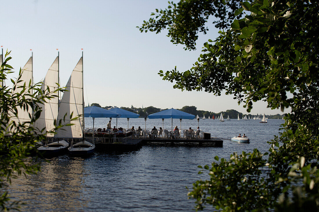 Cafe on jetty, sailing boats on lake Aussenalster, river Alster, Hamburg, Germany