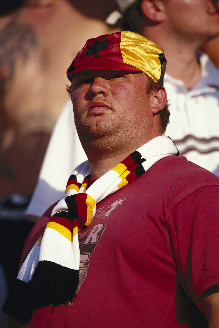German soccer fan wearing cap and scarf