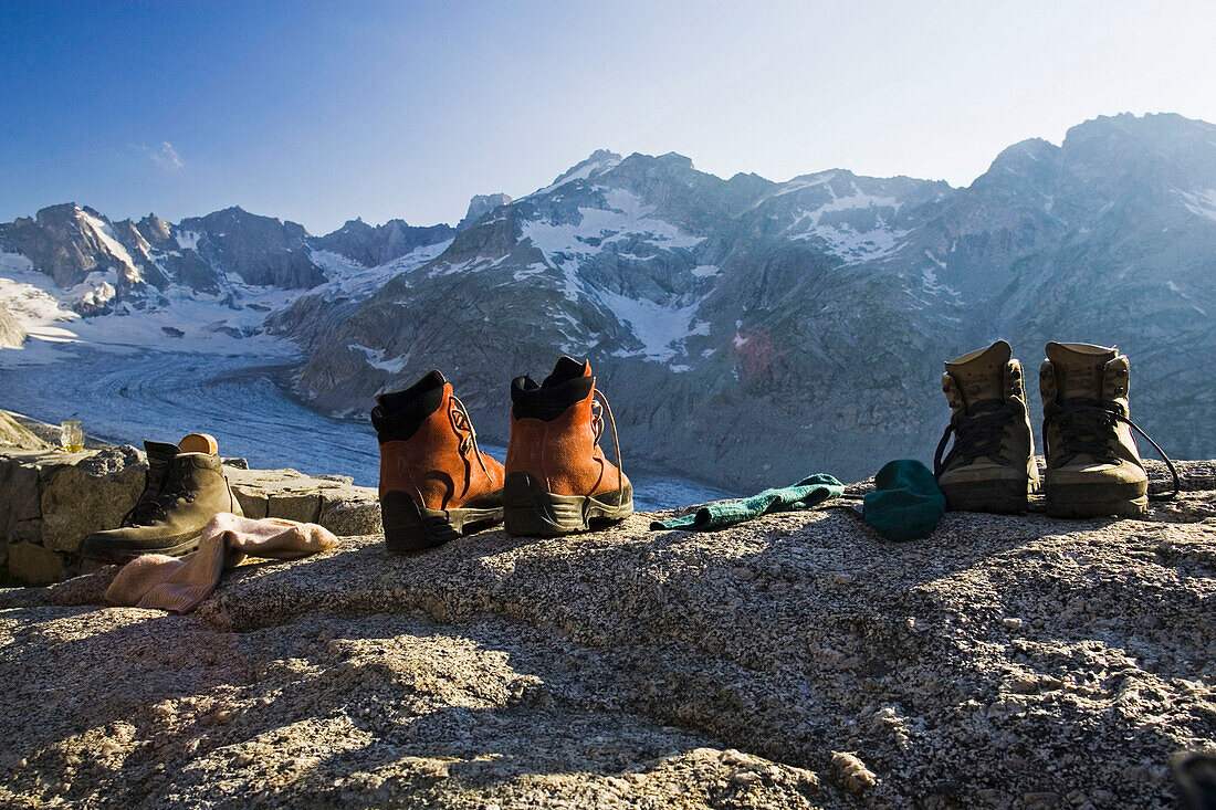 Hiking boots, socks and mountain view. Forno hut, SAC, Bergell, Bregaglia, Graubuenden, Grisons, Switzerland, Alps.