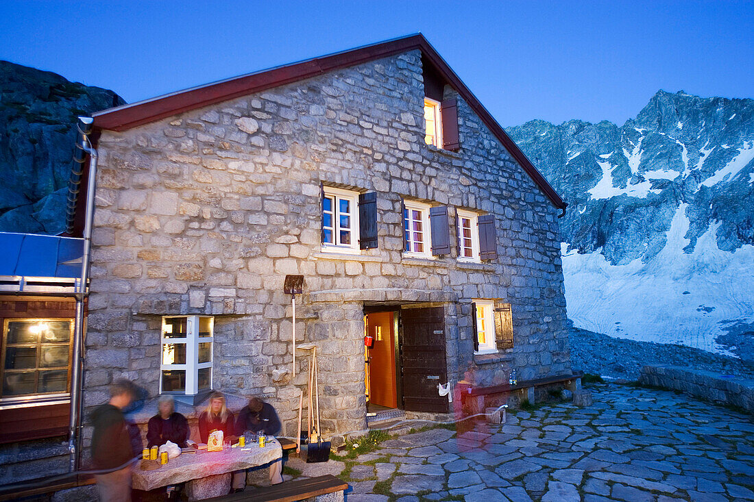 Evening in front of a mountain hut, Forno hut, SAC, Swiss Alpine Club, Bergell, Bregaglia, Graubuenden, Grisons, Switzerland, Alps