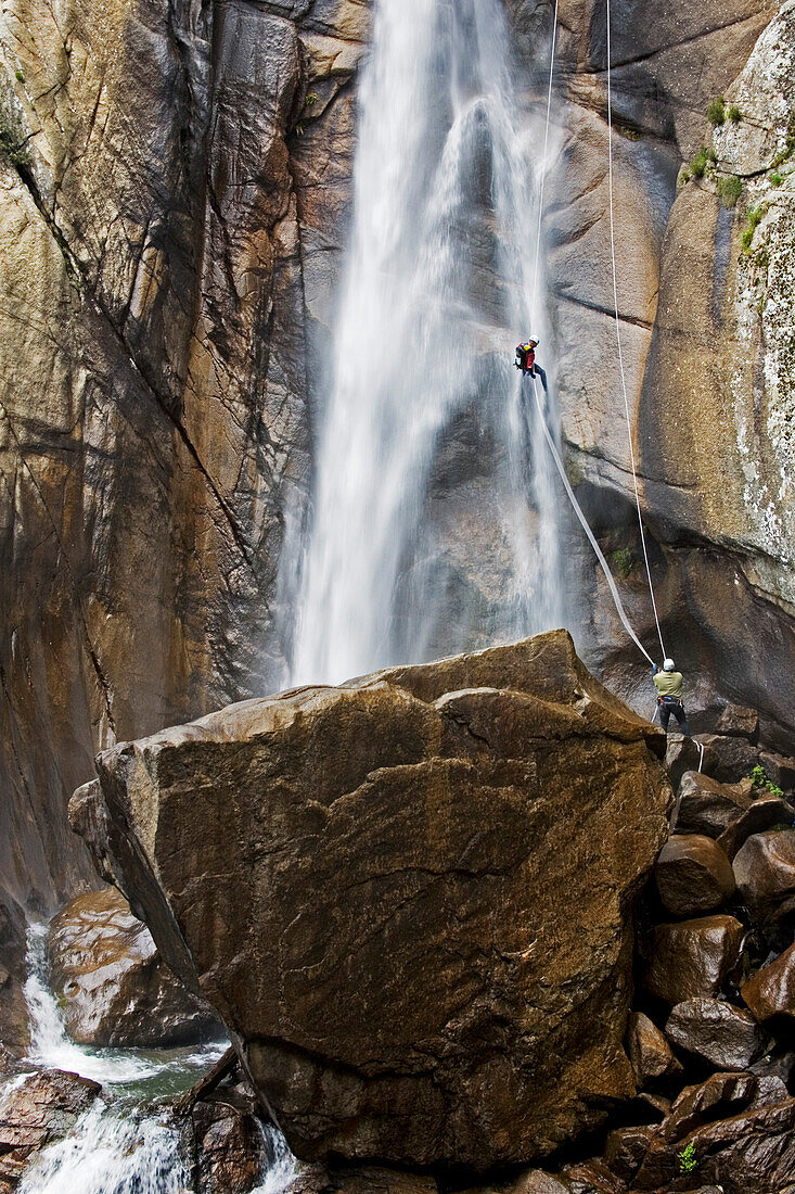 Canyoning, Ein Man seilt in einem Wasserfall ab, Piscia di Gallu, Ospedale, Mittelmeer, Korsika, Frankreich