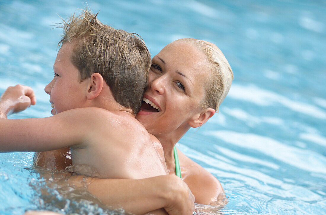 Woman with boy in pool