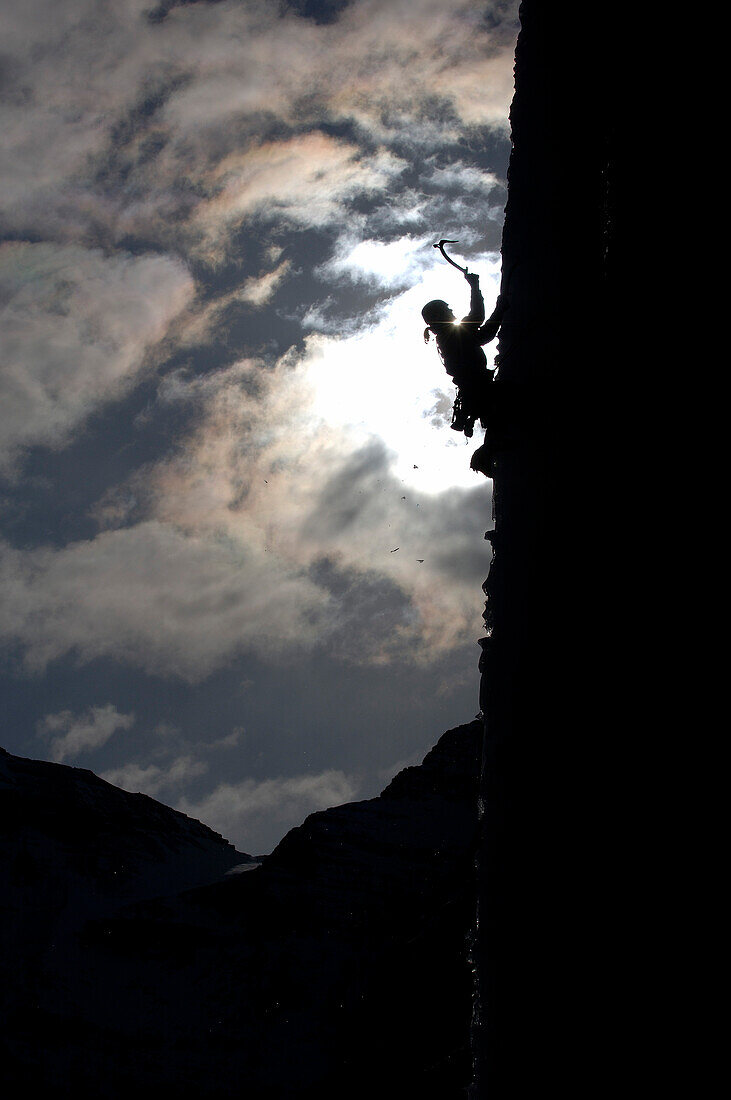 Ice climber at rock face, Stanley Headwall, British Columbia, Canada