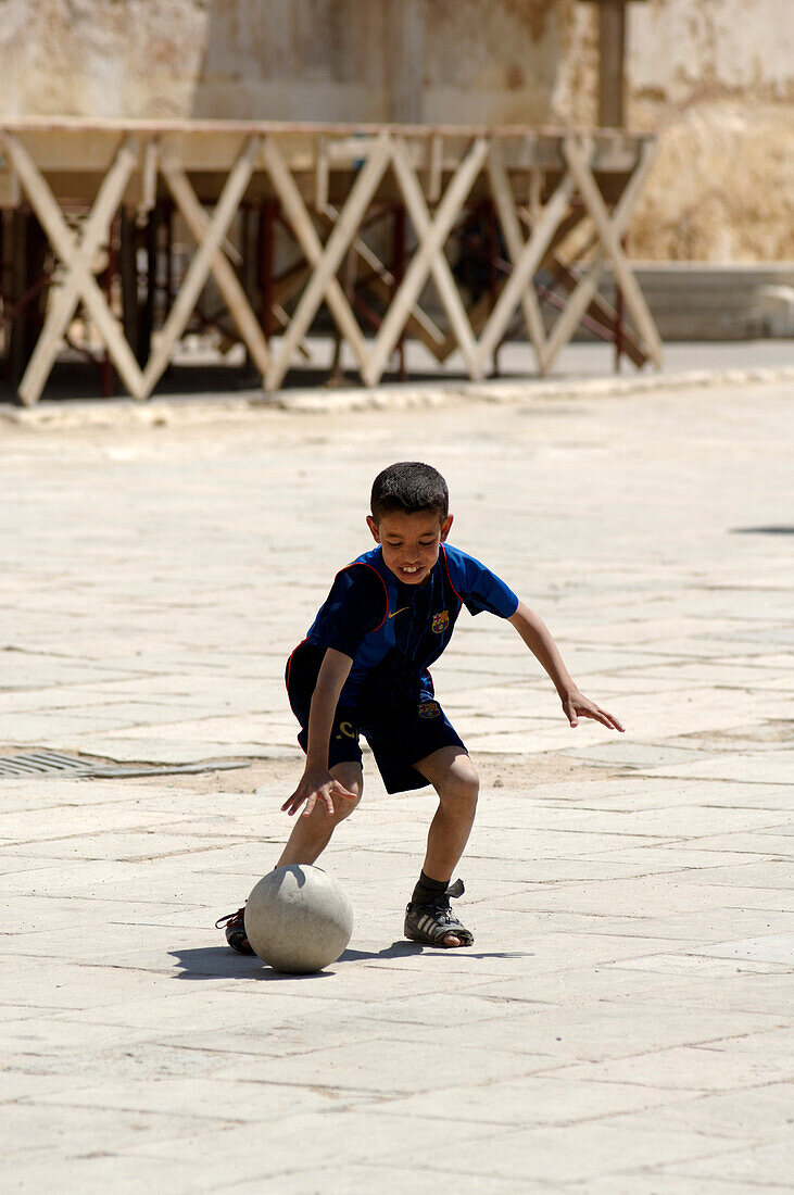 Boy playing football, Place el Hedim, Meknes, Morocco