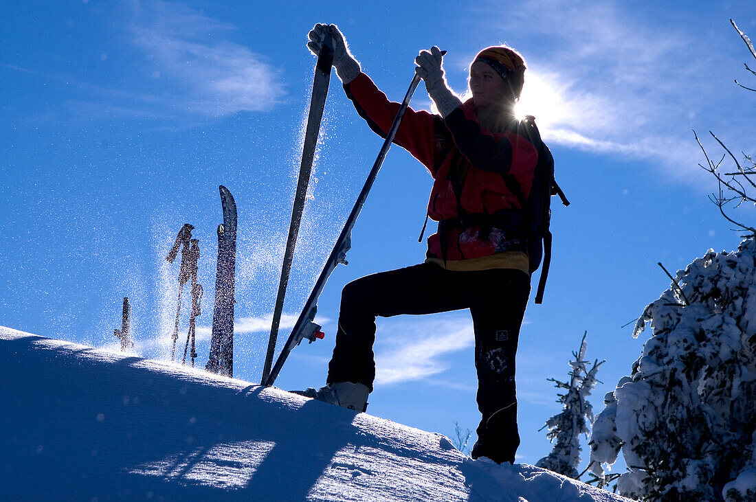 Female ski tourer removing skins, Schwarzkogel, Austria
