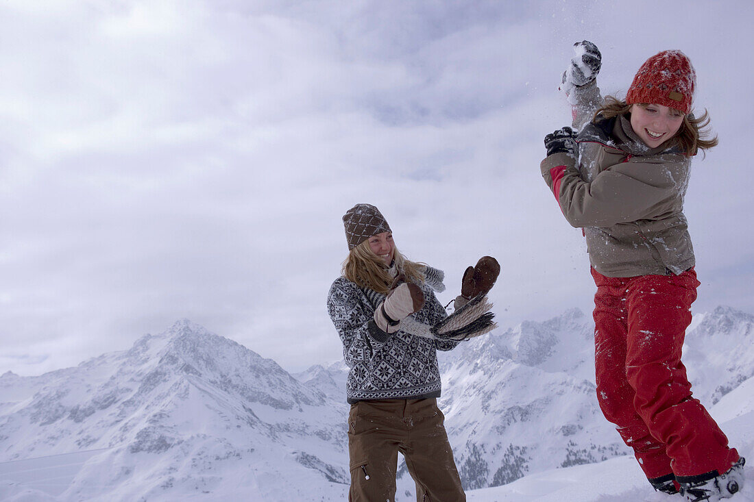 Two young women, Snowball fight, Kuehtai, Tyrol, Austria