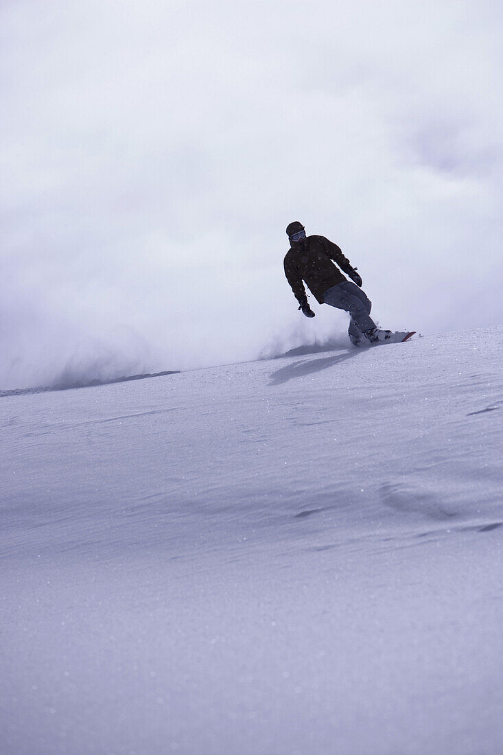 Snowboarding on mountain slope, Kuehtai, Tyrol, Austria