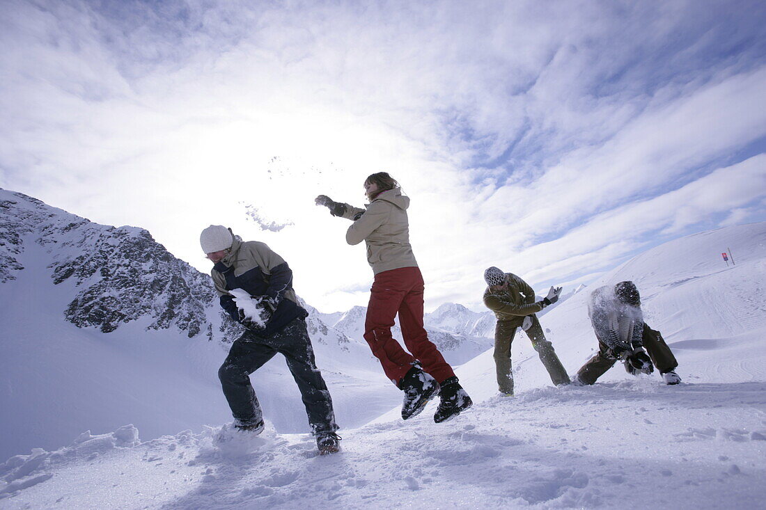 Junge Leute haben Spaß mit einer Schneeballschlacht, Kühtai, Tirol, Österreich