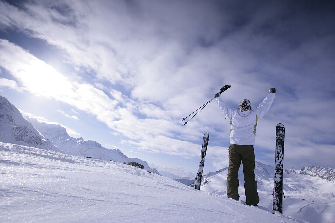 Junger Skifahrer hebt die Arme in die Höhe, Kühtai, Tirol, Österreich