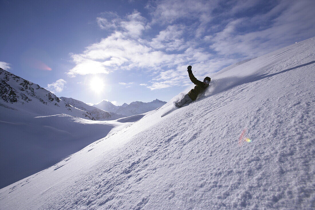 Snowboarding moving down in powder snow, Kuehtai, Tyrol, Austria