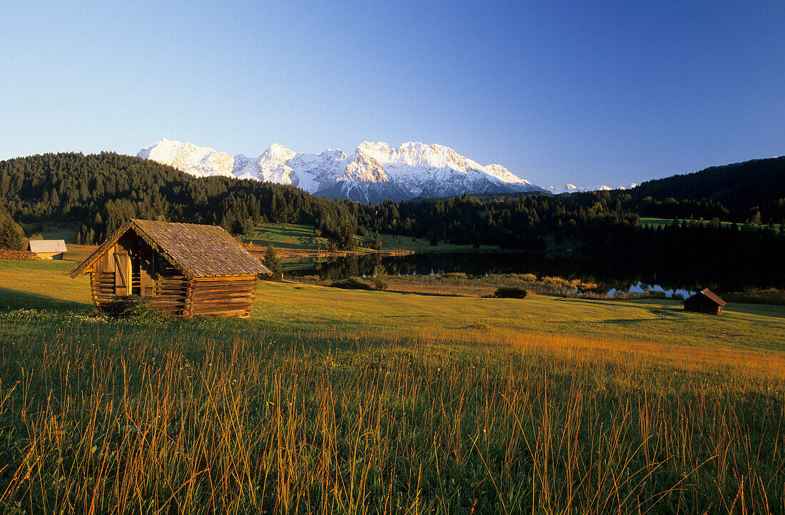 Lake Geroldsee with haystack and view to Karwendel, Wetterstein Mountains, Upper Bavaria, Germany