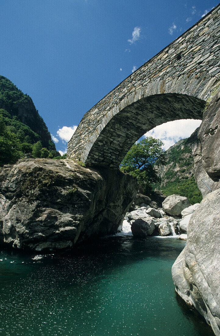 River with traditional stone bridge near Fontana, Ticino, Switzerland