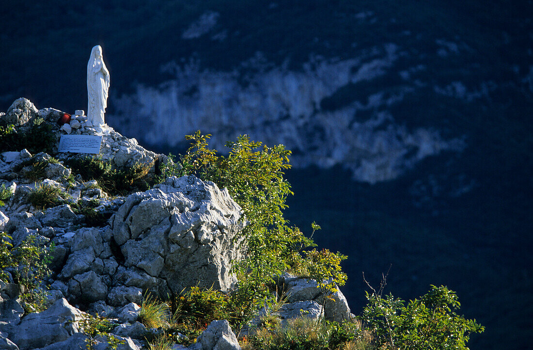 Madonna statue made from white marble on a cliff, Monte Colodri, Trentino, Italy