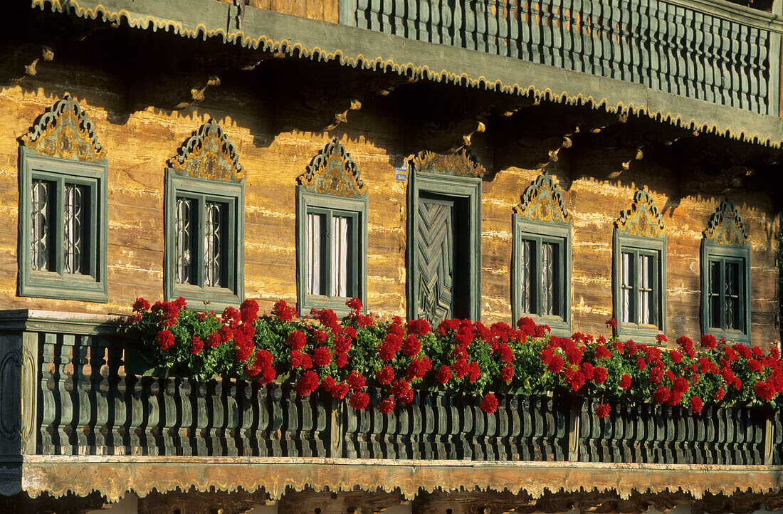 Traditional farmhouse with wooden block construction and flowers, Festenbach, Upper Bavaria, Germany