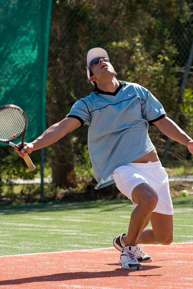 Male tennis player celebrating on court, Apulia, Italy