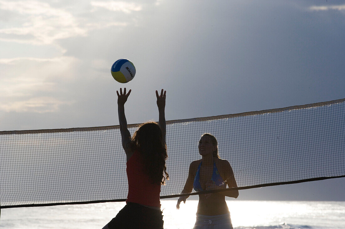 Young people playing beach volleyball, Apulia, Italy