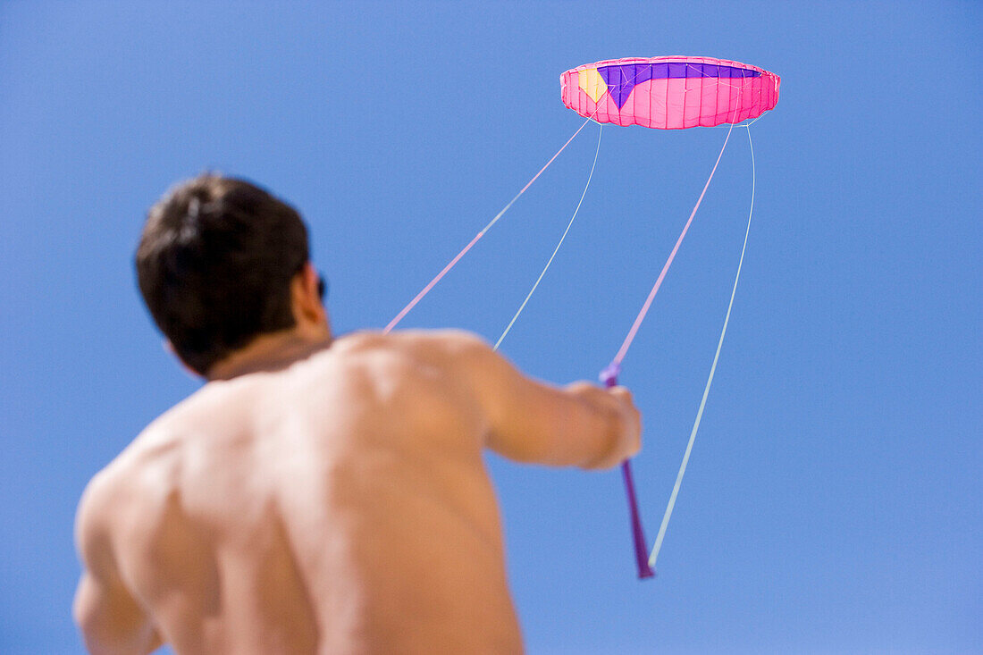 Young man holding kite string, Apulia, Italy