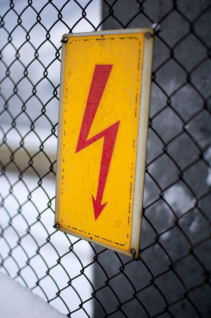 Electricity sign on a fence