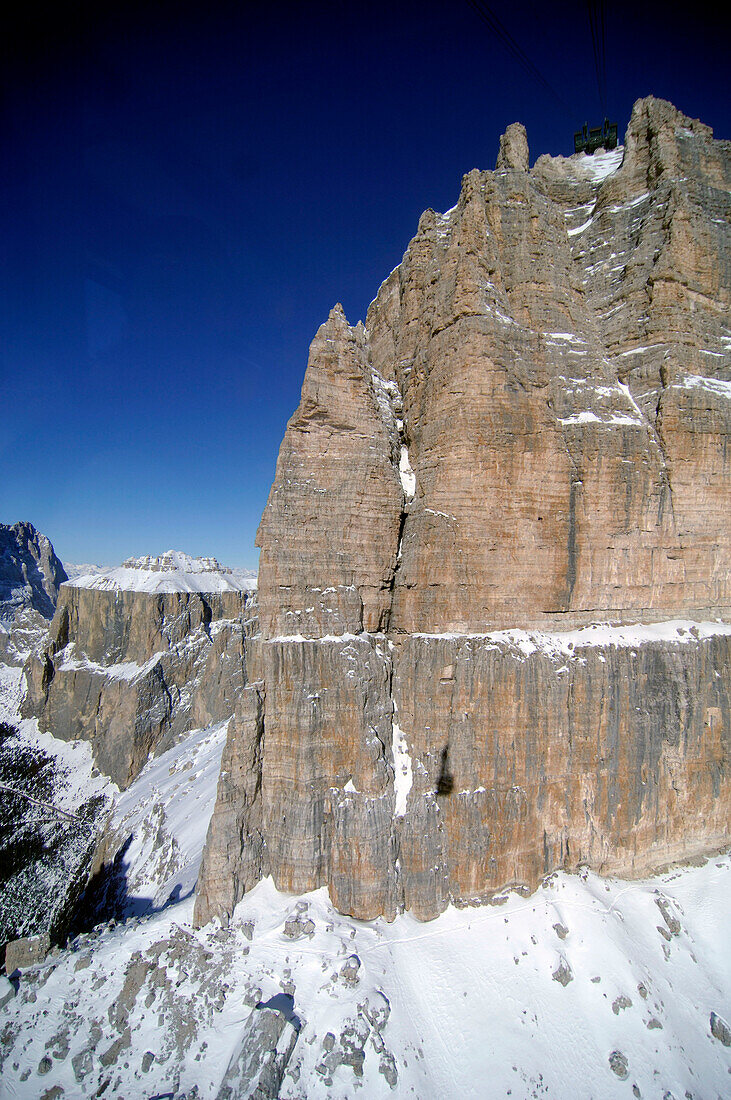 Snow covered rocks under blue sky, Passo Pordoi, Dolomites, Italy, Europe