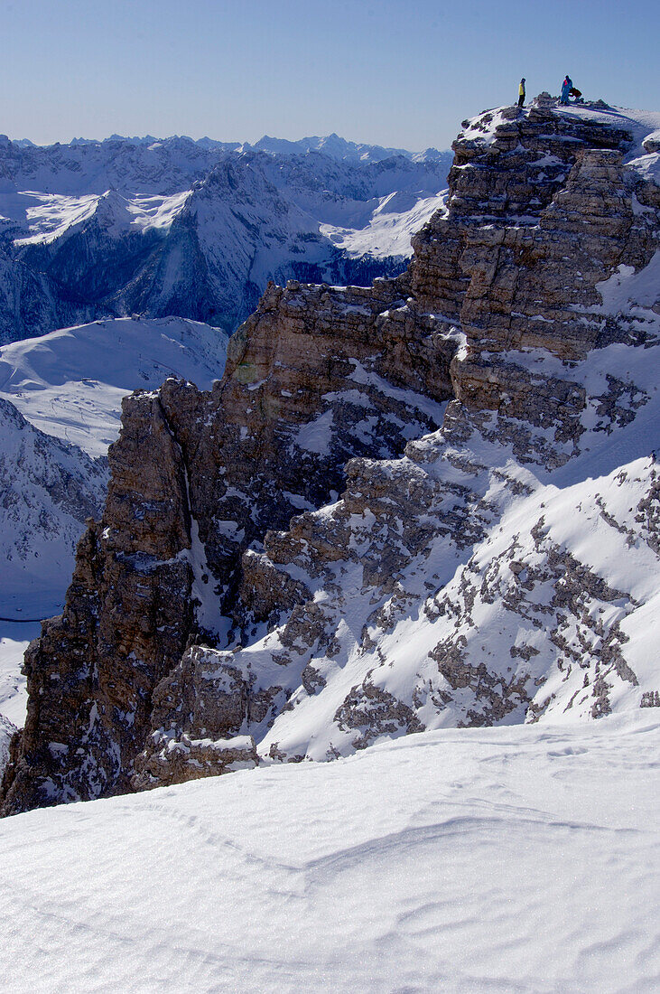 Two persons on mountain summit, Passo Pordoi, Dolomites, Italy