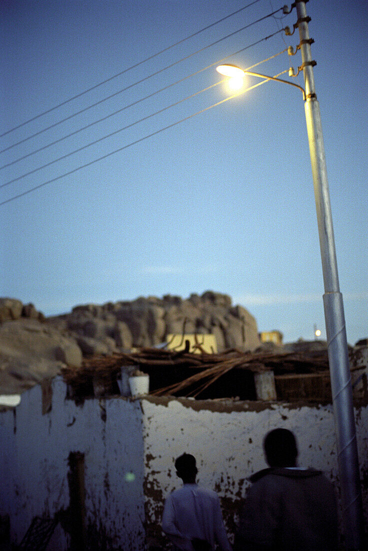 People walking in the early morning through the town, Aswan, Egypt