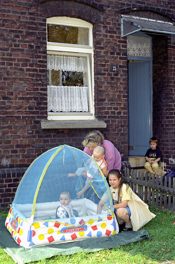 Family with children in the garden, Essen, North-Rhine Westphalia, germany, Europe