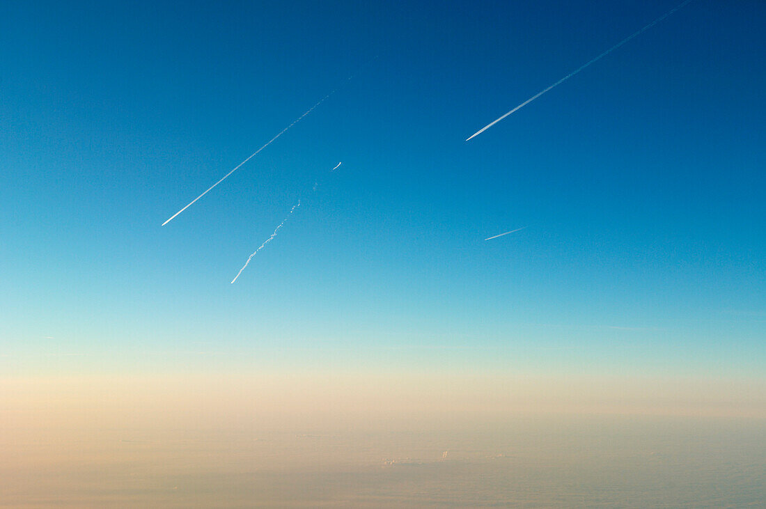 Mehrere Flugzeuge mit Kondensstreifen über dem Horizont