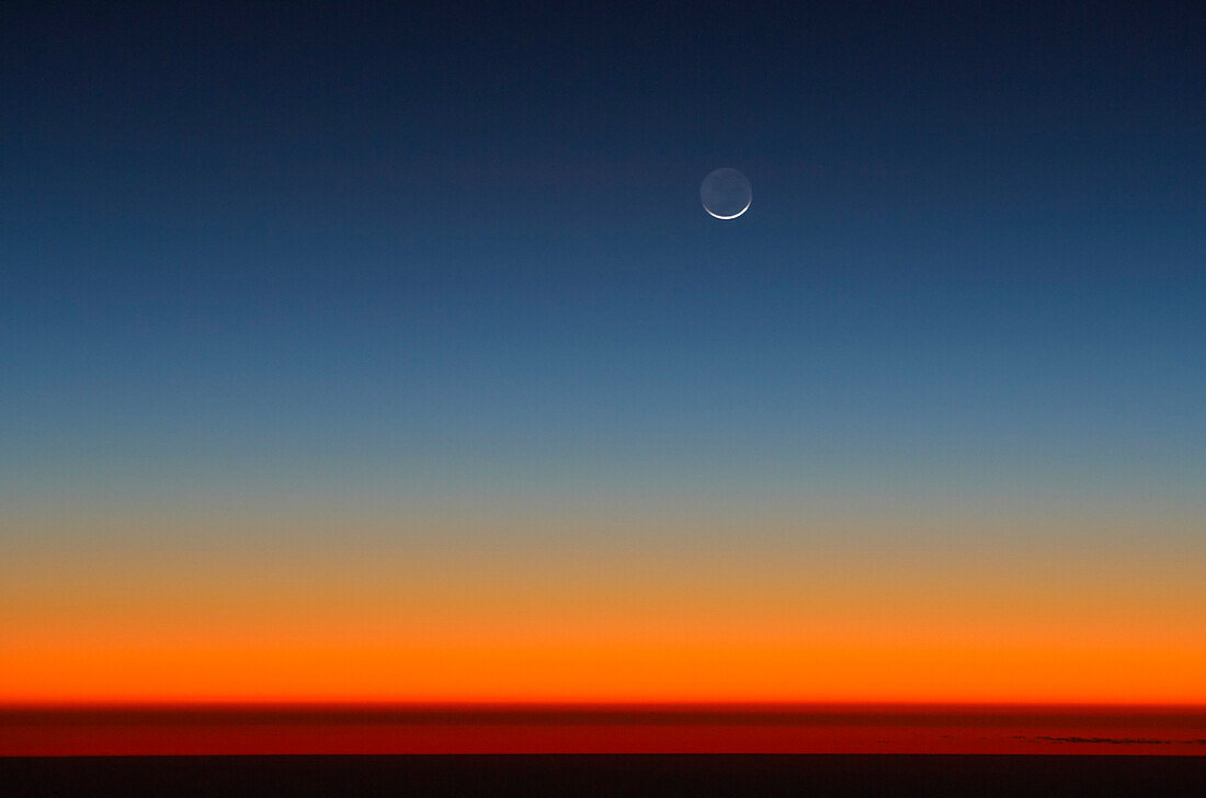 Crescent of moon above Horizon after sunset
