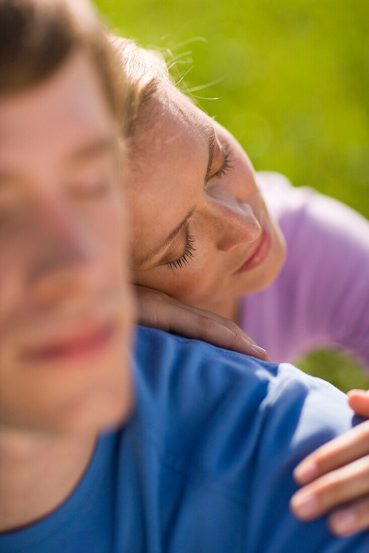 Woman leaning head on man's back