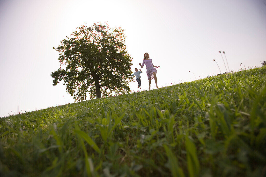Couple running on meadow