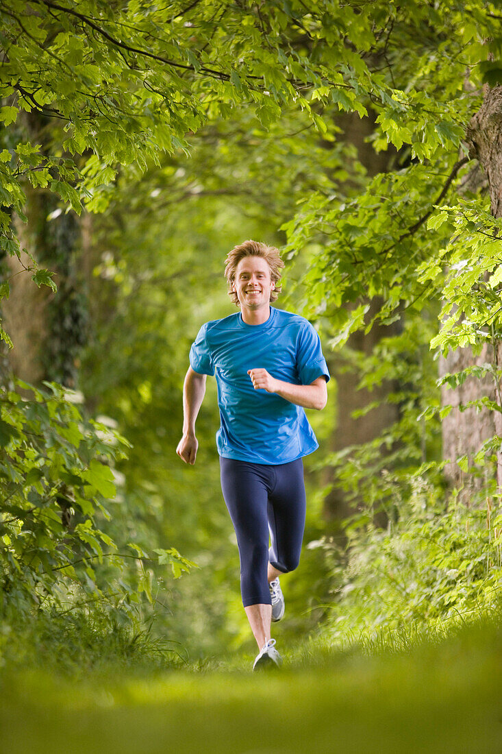 Young man jogging in woods