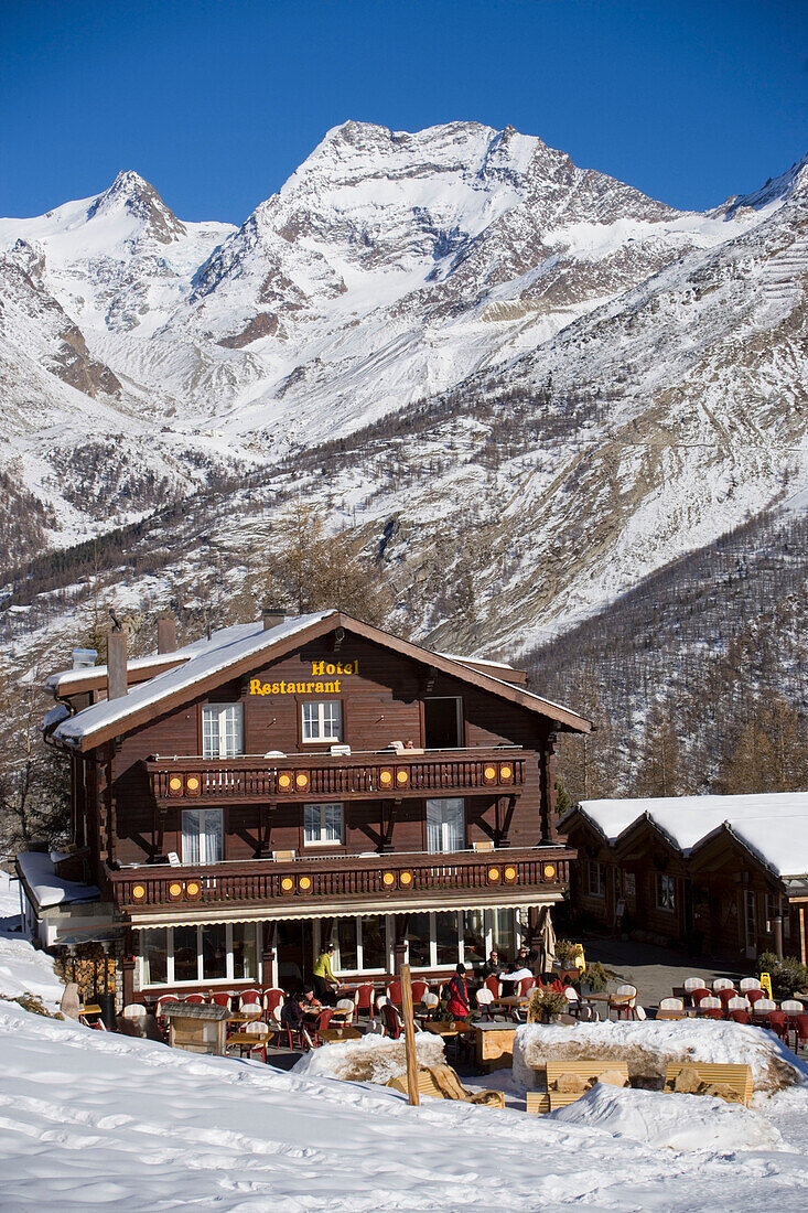 Hotel and Restaurant Hohnegg in front of a snowy mountain, Saas-Fee, Valais, Switzerland