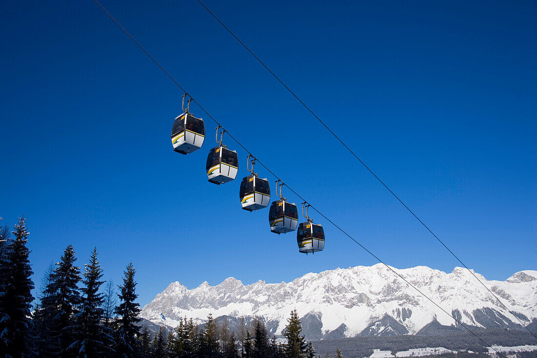 Overhead cable car and Dachstein Mountains at horizon, Hochwurzen, Schladming, Ski Amade, Styria, Austria